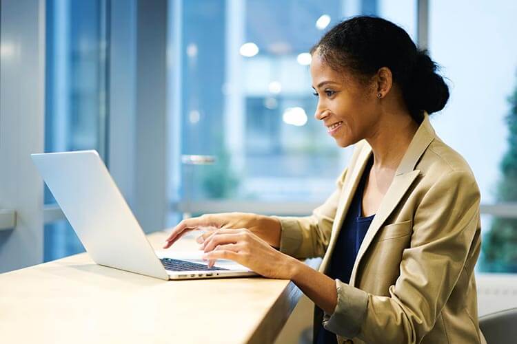 Man and woman looking at laptop while at the office